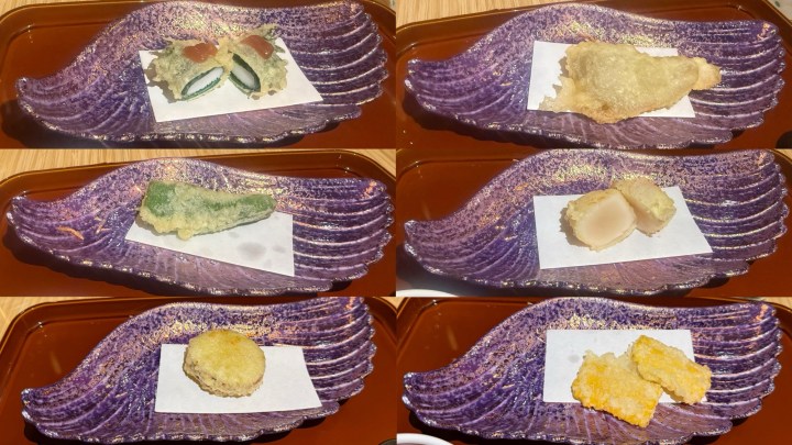 An array of elegantly presented tempura dishes on a decorative plate, featuring various vegetables and seafood, each served on a small sheet of paper.