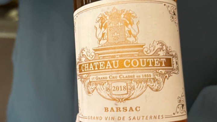 Close-up of a wine bottle label featuring Chateau Coutet, a Barsac Grand Vin de Sauternes from the year 2018.