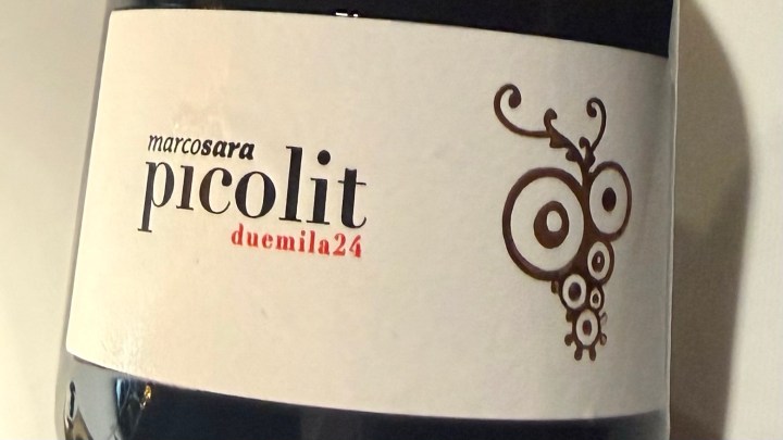 Close-up of a wine bottle label featuring the text 'marcosara picolit duemila24' along with a stylized owl logo.