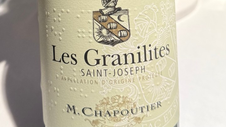 Close-up of a wine bottle labeled 'Les Granilites' from Saint-Joseph, featuring the producer's name M. Chapoutier and a decorative emblem.