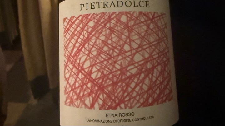 A close-up image of a wine bottle label featuring the name 'Pietradolce' at the top, with a decorative red scribble design and the text 'Etna Rosso' and 'Denominazione di Origine Controllata' below.