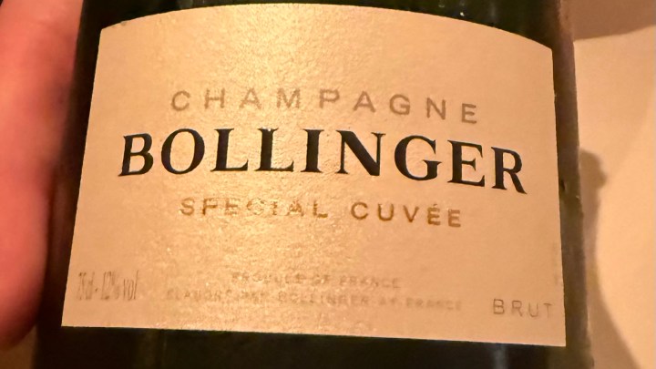 A close-up of a Bollinger Special Cuvée champagne bottle label, featuring gold and black text on a textured background.