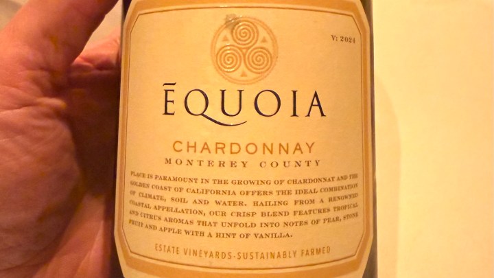 A close-up image of a wine bottle label featuring ÉQUOIA Chardonnay from Monterey County. The label includes details about the wine's origin and tasting notes highlighting tropical fruit, pears, and a hint of vanilla.